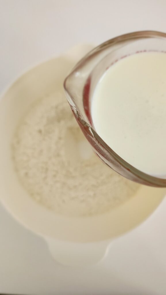 Adding buttermilk to flour and butter mixture