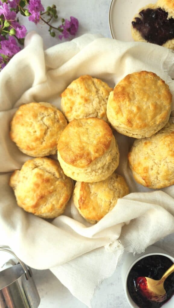 Buttermilk Biscuits in a basket with jam to the side