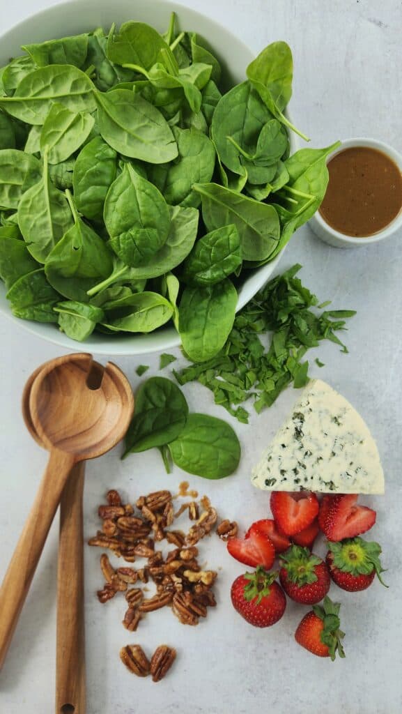 spinach strawberry salad - all the ingredients - spinach, strawberries, blue cheese, maple-glazed pecans, balsamic vinaigrette