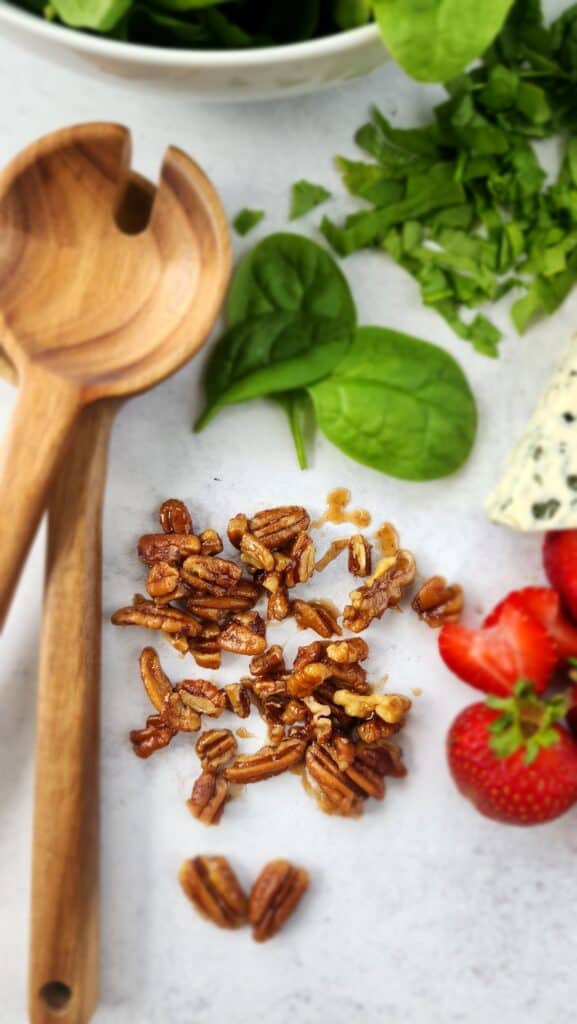 spinach strawberry salad ingredients - close up of maple-glazed pecans