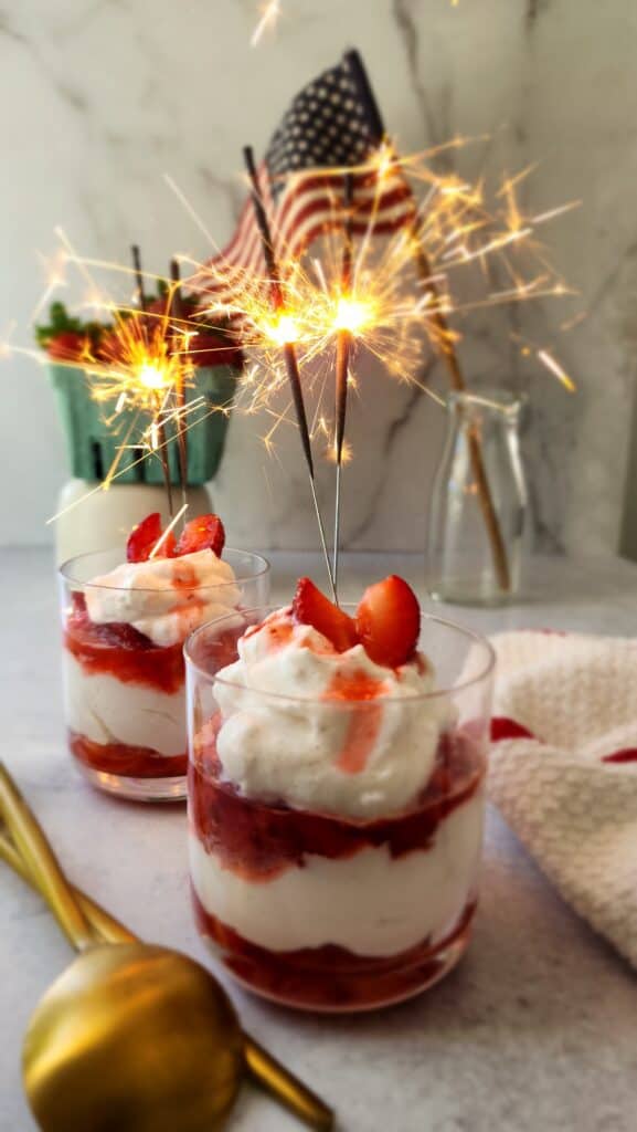 Strawberry Fool in cups with sparklers lit