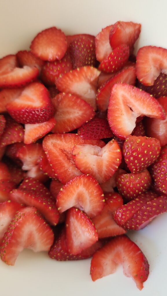 sliced strawberries in a bowl