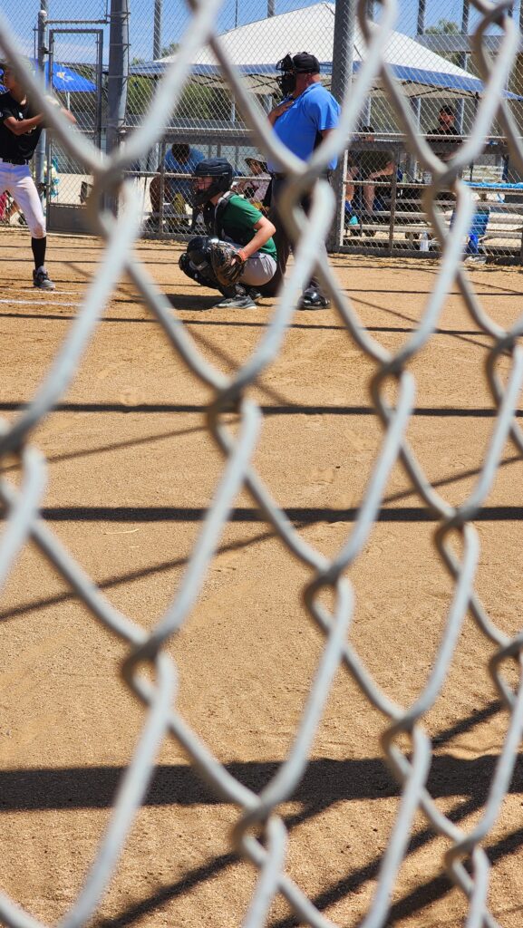 Joshua catching in a baseball game