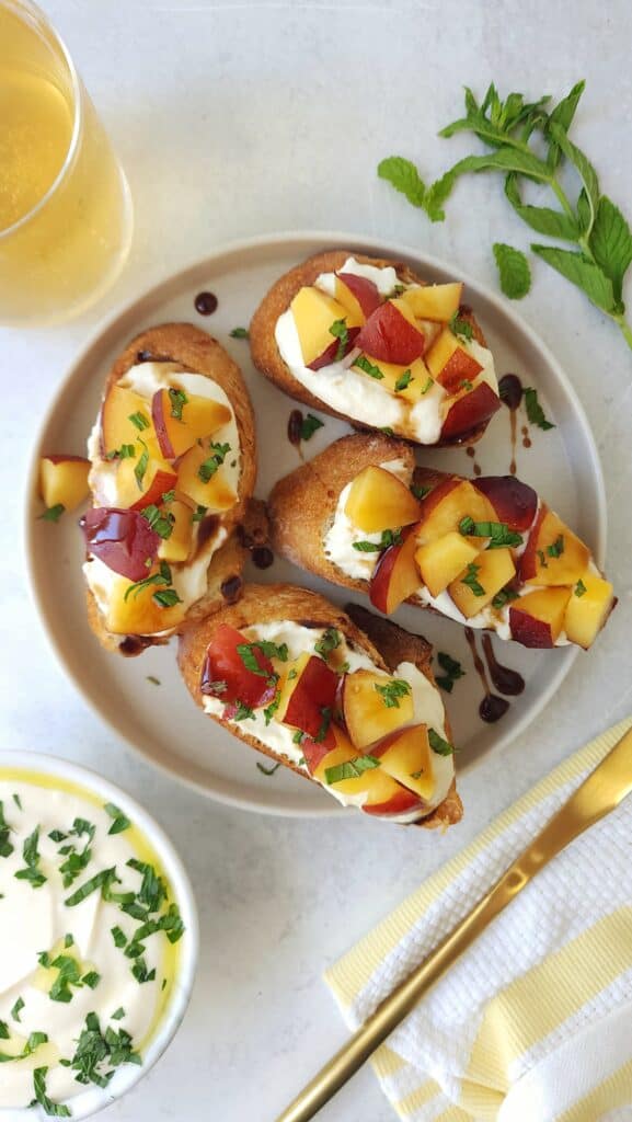 plate of nectarine crostini with whipped ricotta