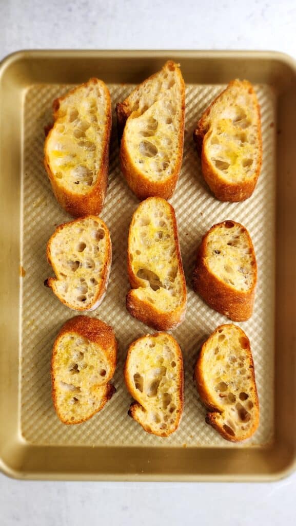 Bread slices toasted on a baking sheet