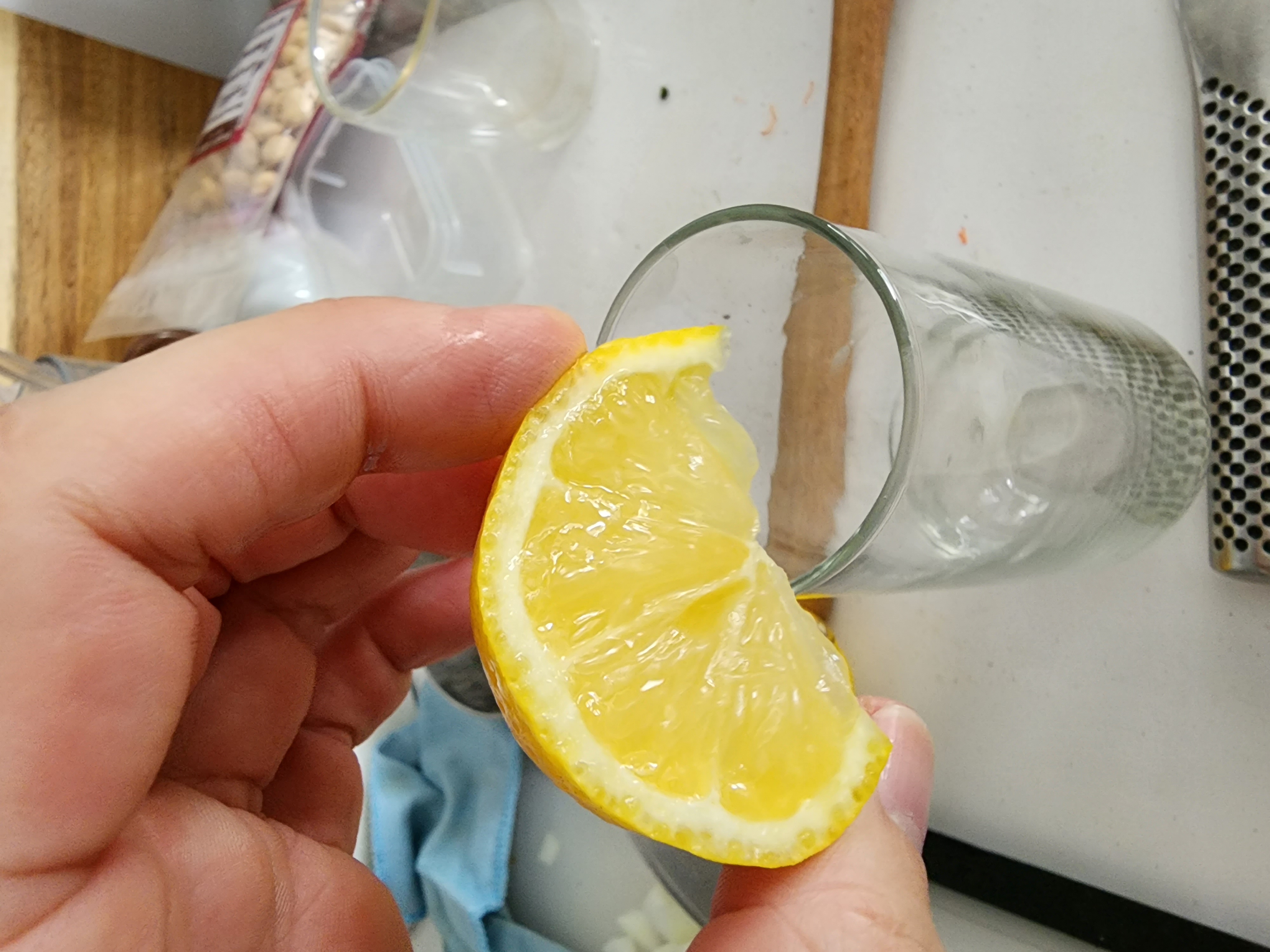 lemon wedge running over the rim of a champagne glass