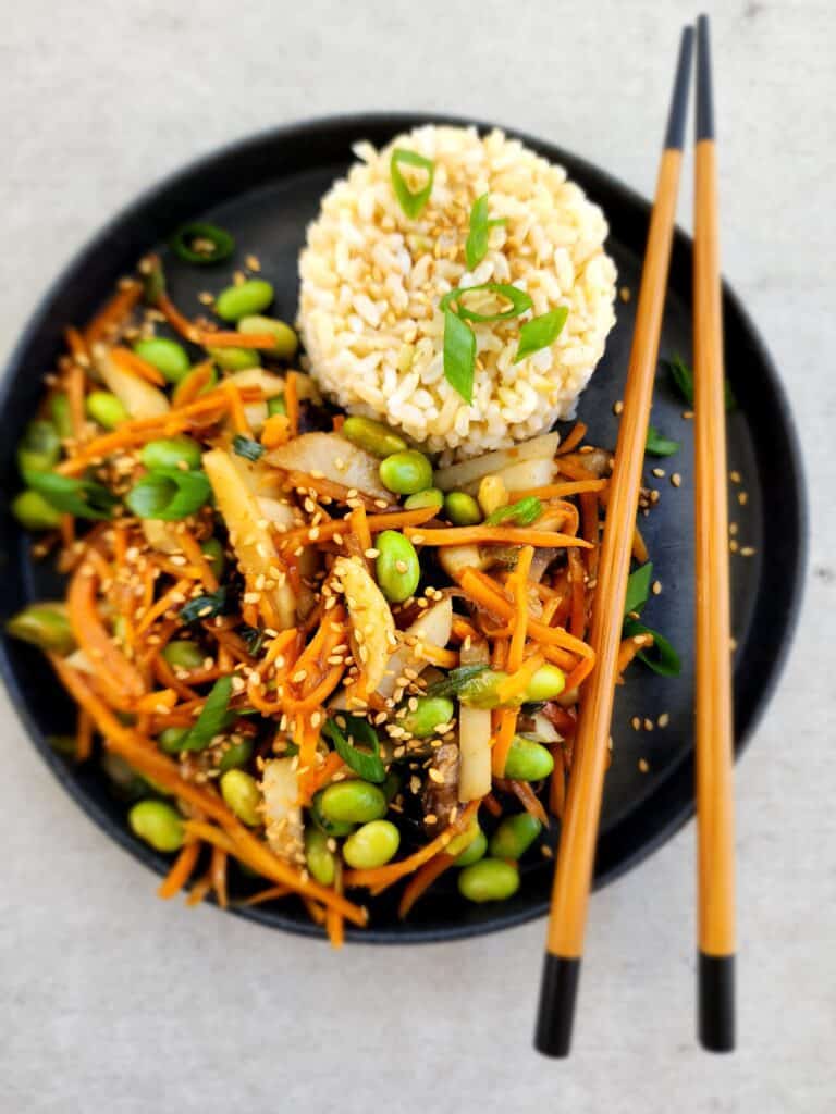 Plated Easy Veggie Stir-Fry with brown rice and chopsticks