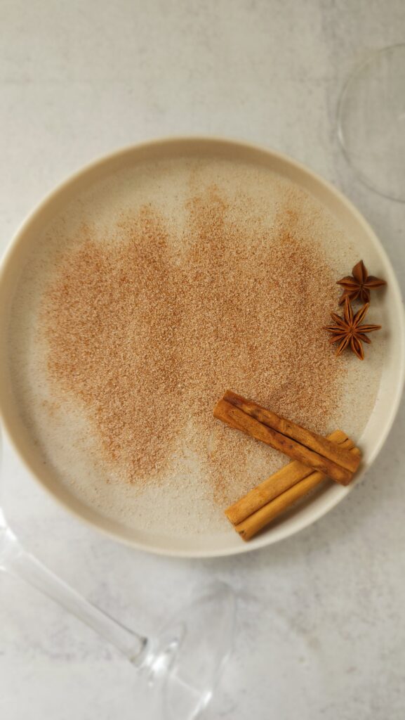 plate of cinnamon sugar with a cinnamon stick and star anise