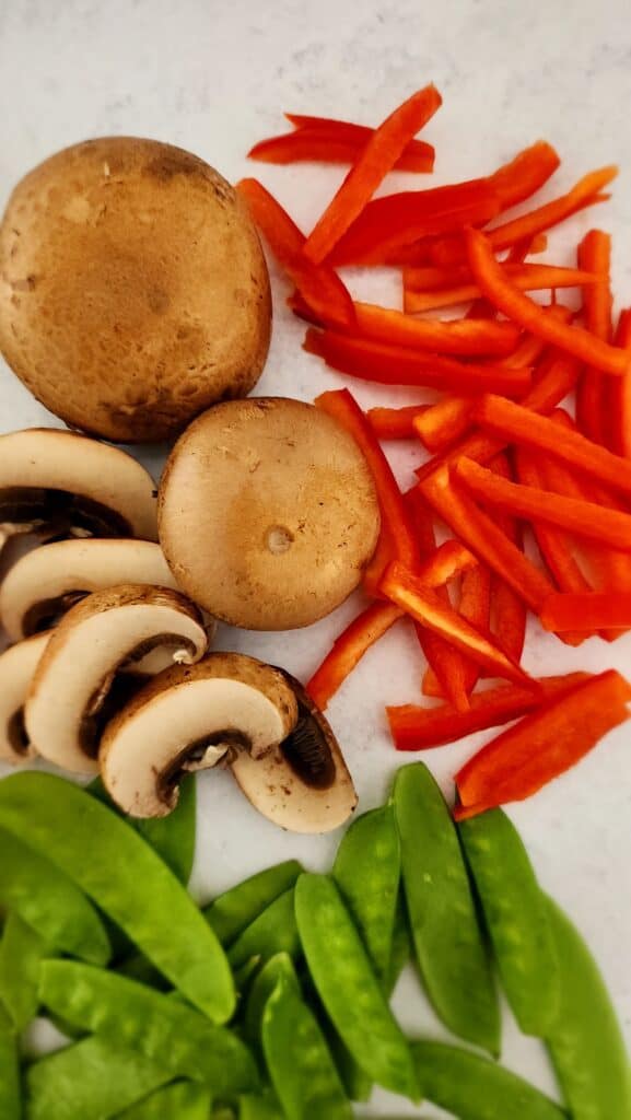 close up of mushrooms and red bell pepper sliced for an easy veggie Stir-fry