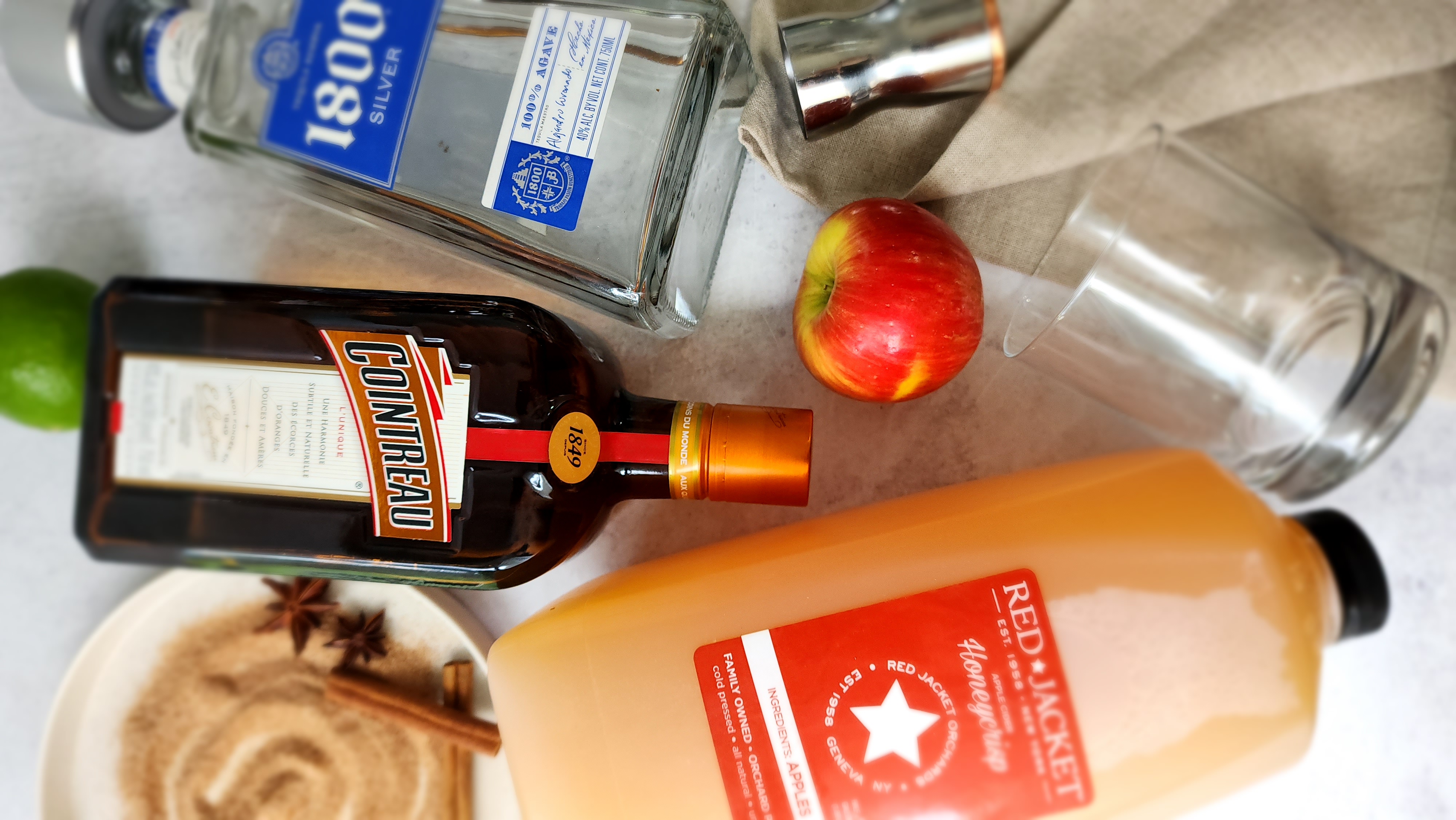 ingredients for an apple cider margarita:  apple cider, tequila, cointreau, lime, cinnamon sugar