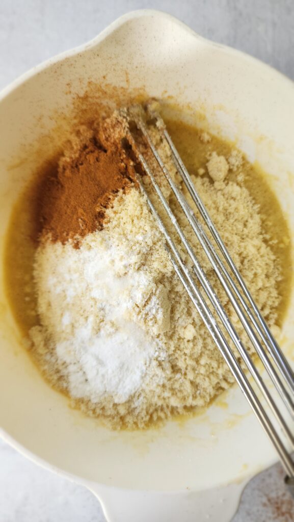 Cinnamon, vanilla, and baking powder added to almond flour, eggs, and mashed banana for baby's 1st smash cake