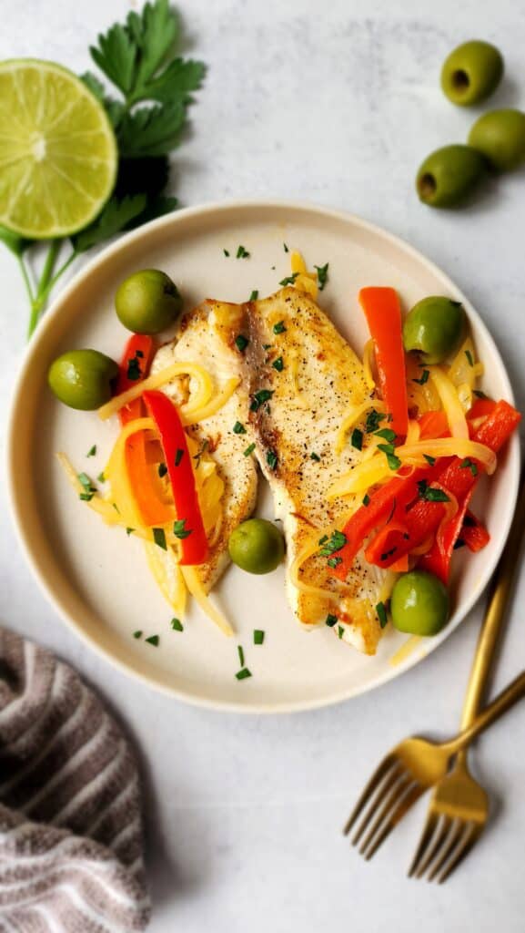 plated tilapia with peppers, onions, and olives