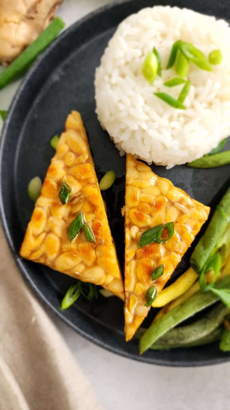 Close-up of sauteed tempeh with a sesame ginger sauce